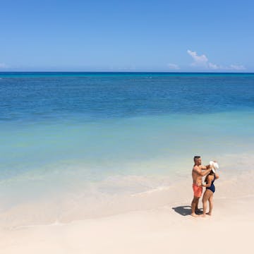 Dreams Rose Hall a couple chatting on the beach.