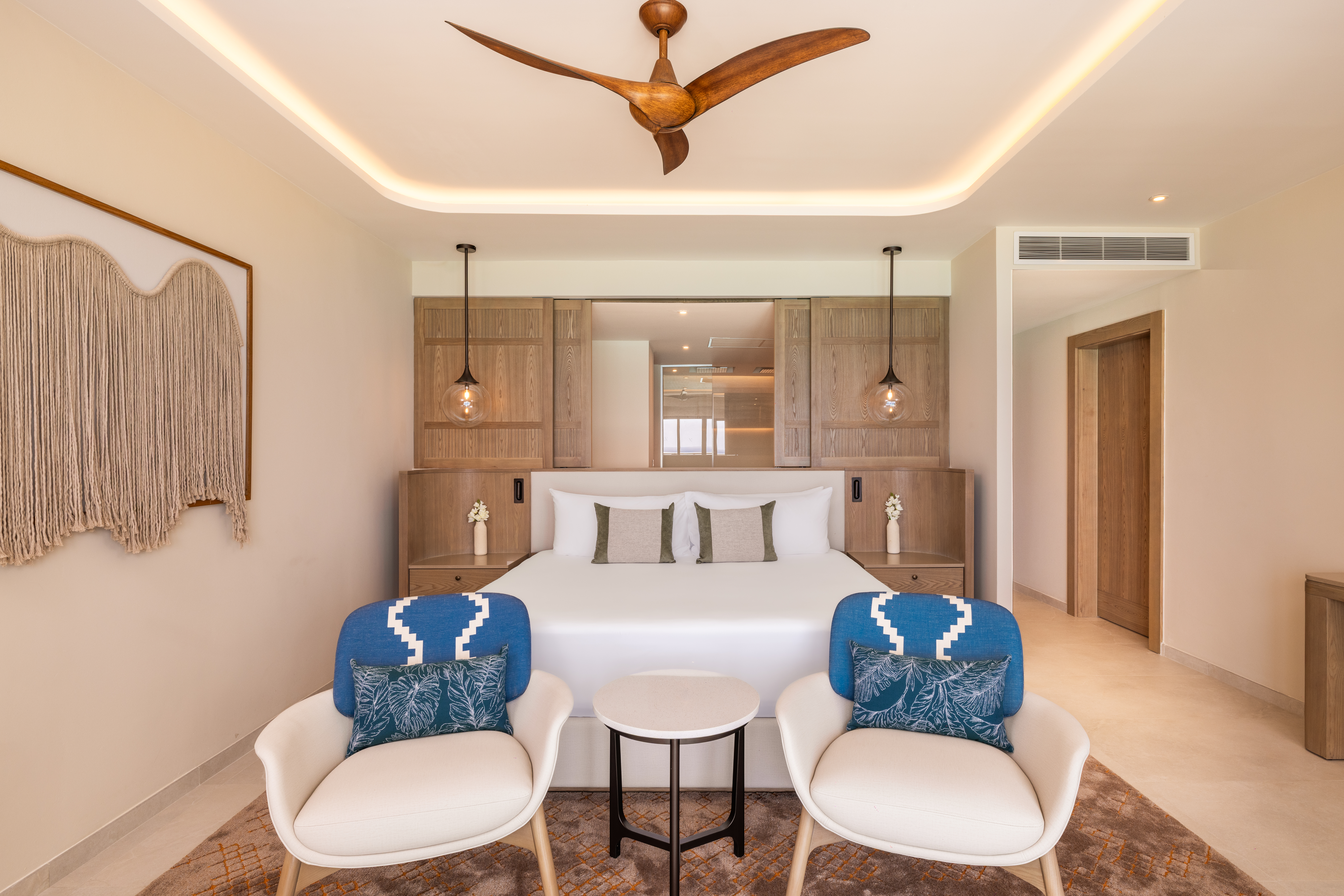 Elegant suite at Hyatt Zilara Cancun with king bed, modern décor, and seating area.
